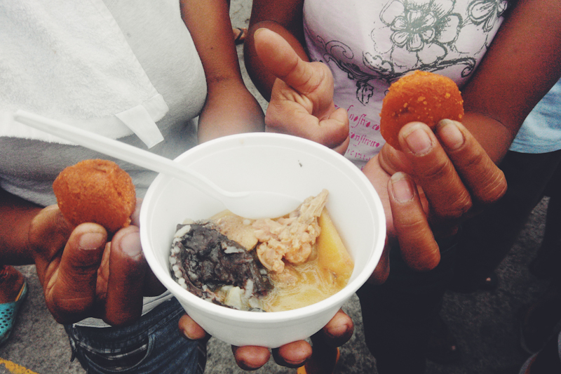 Onlookers have their share of the Valenzuela delicacy "putong pulo" with "kinulob na manok" during a part of a series of celebration for the city's 391st foundation day.